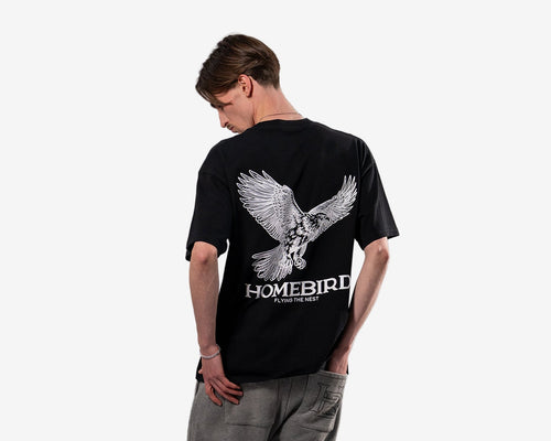 Person wearing a black t-shirt with an eagle design and 'Homebird' text on a white background